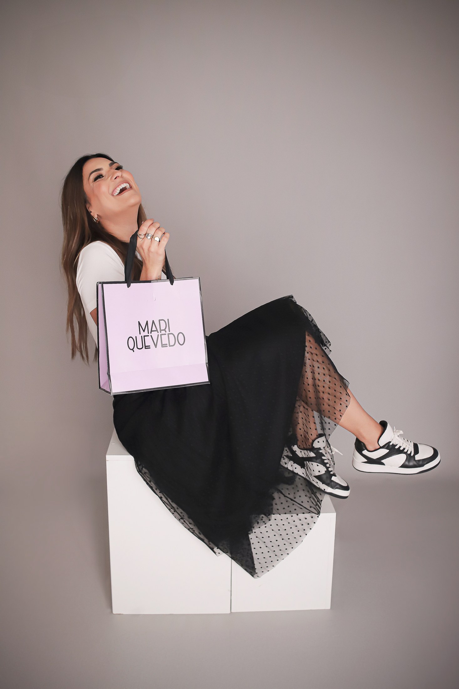 Mariella Quevedo sorrindo com sacola Mari Quevedo